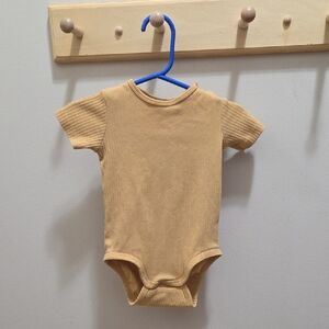 Cozy Tan Ribbed Baby Onesie